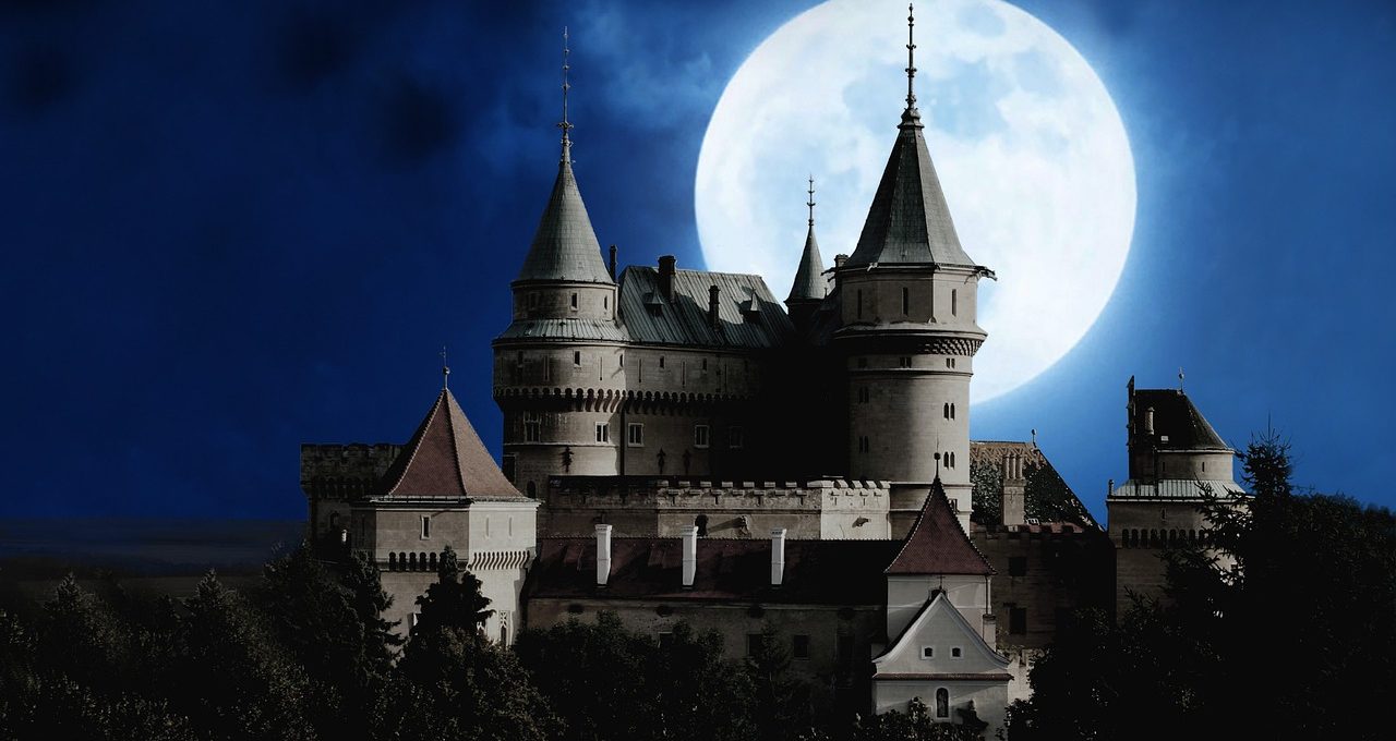 Bran Castle in Transylvania, Romania under a full moon during Halloween is one of the haunted castles in europe