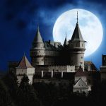 Bran Castle in Transylvania, Romania under a full moon during Halloween is one of the haunted castles in europe