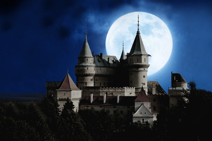 Bran Castle in Transylvania, Romania under a full moon during Halloween is one of the haunted castles in europe