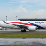 Malaysia Airlines aircraft ready for departure on the runway.