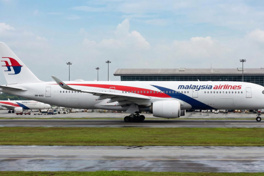 Malaysia Airlines aircraft ready for departure on the runway.
